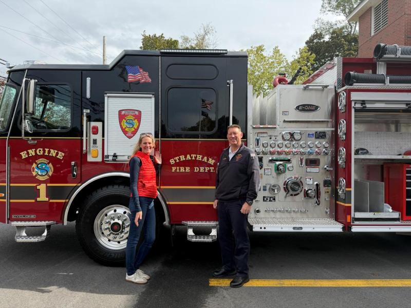 Two people a man and a woman next to Engine 1. 